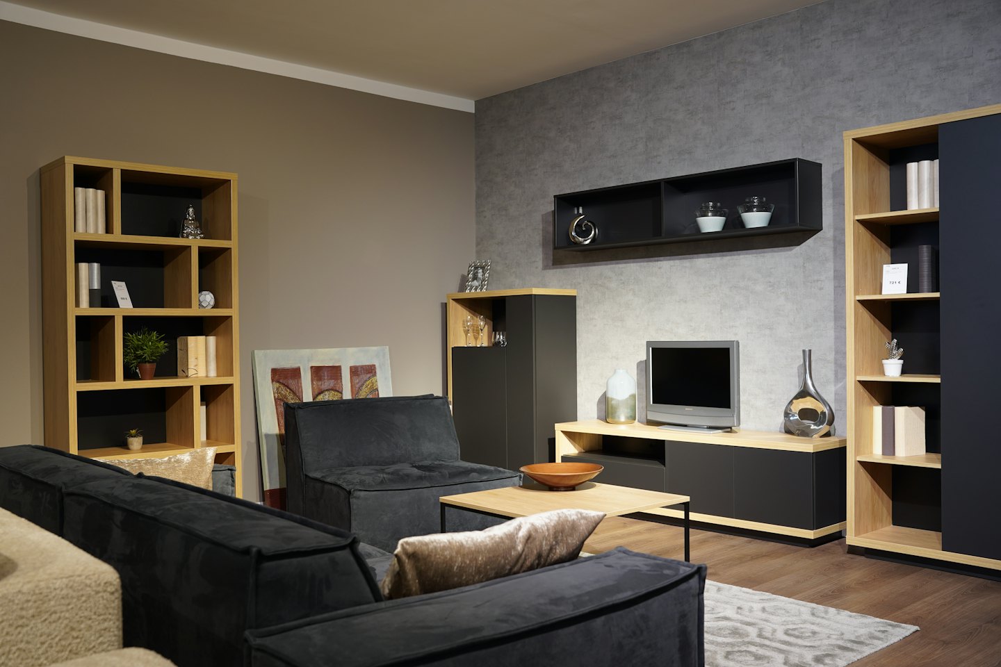Living room with modular sofas, wood shelving, and a CRT television.